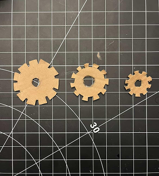 Then, we tried to make actual gear shapes with the cardboard, cutting out the teeth of the gears, and making a range of sizes.