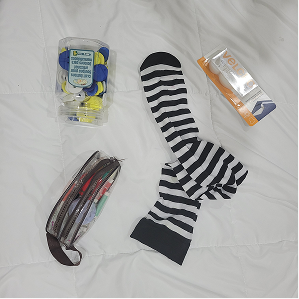 This is a layout of all of my materials I had gathered for my prototype testing phases. I focus on the outer band materials, and gathered here are some buttons, a sewing kit, some velcro, and some stockings to use as the base of my resistance band.