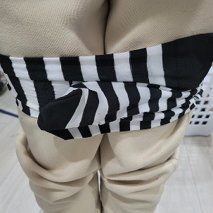 Moving forward through to the next test, I tried using velcro to create a more secure fastening method for the resistance band. I stuck one side of the velcro to the stocking, and left the other side free to wrap around my legs. This method was much more effective, as it held up well under tension and was easy to put on and take off.